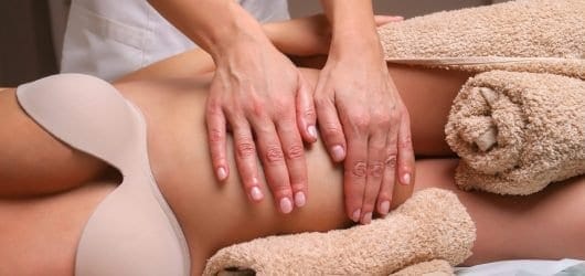 Pregnancy Massage Image of Massage therapist massaging pregnant woman.