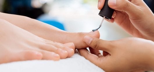 Class Pedicare Image of Close-up of pedicurist applying nail polish to the toenails.