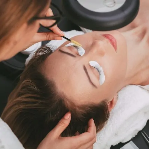 Image of Beautician preparing model for a lash and brow tint.