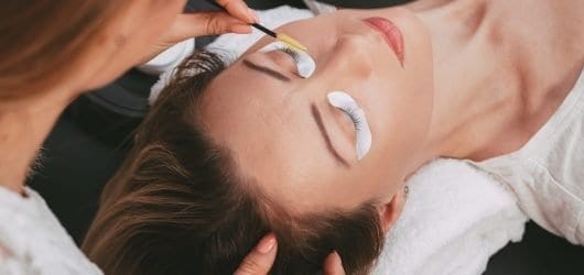 Eyelash Tint Image of Beautician preparing model for a lash and brow tint.
