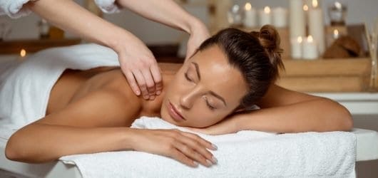 Aroma Swedish Massage Young woman having massage relaxing in spa salon.