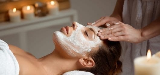 Restart Facial Young woman in mask for face relaxing in spa salon.