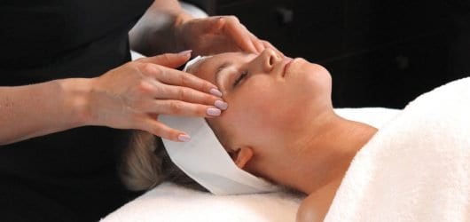 Fresh Start Facial and Skin Consult Young woman on a beauty spa bed, receiving a tailored skin consultation by a beauty therapist.