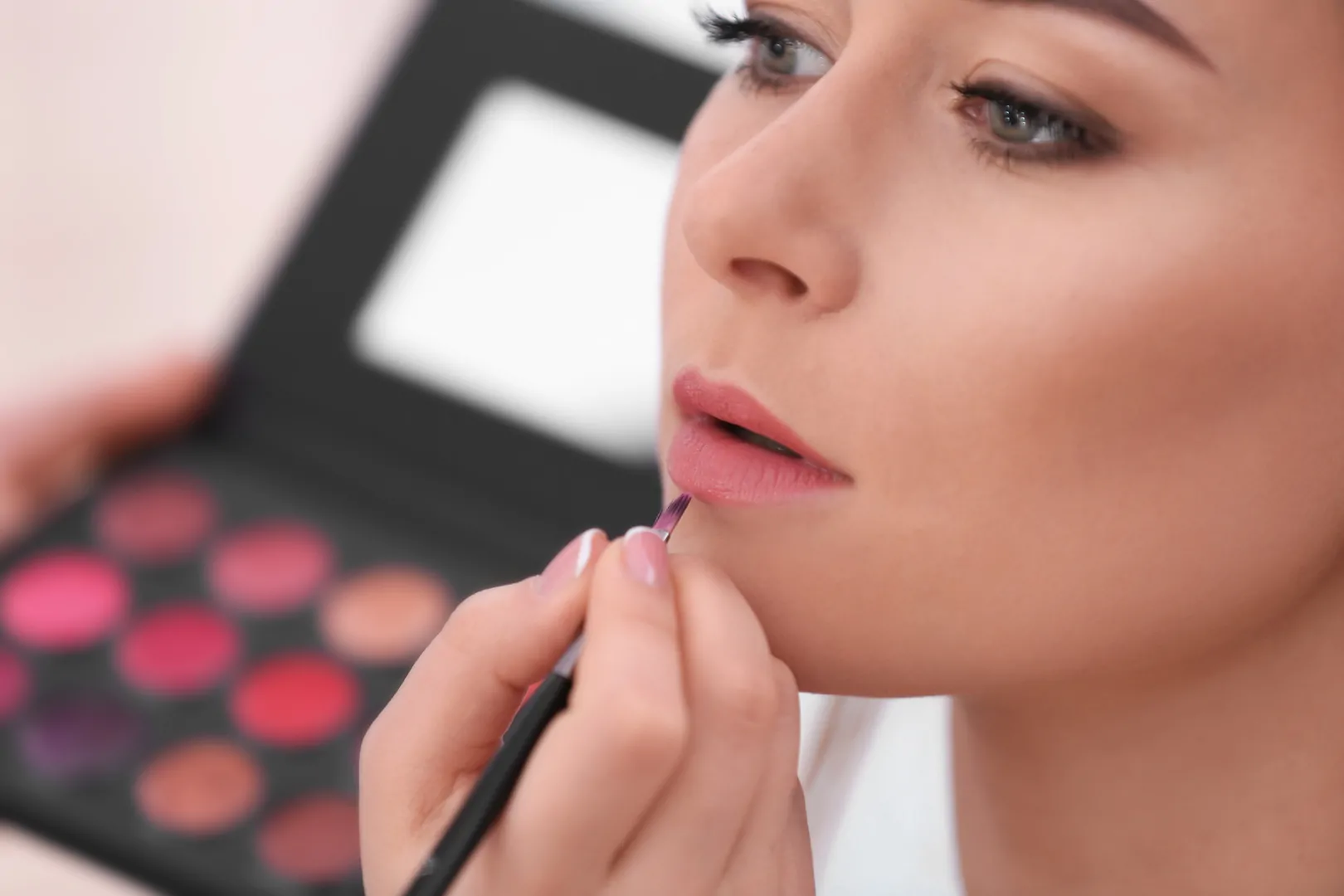 Image of a woman having makeup applied professionally