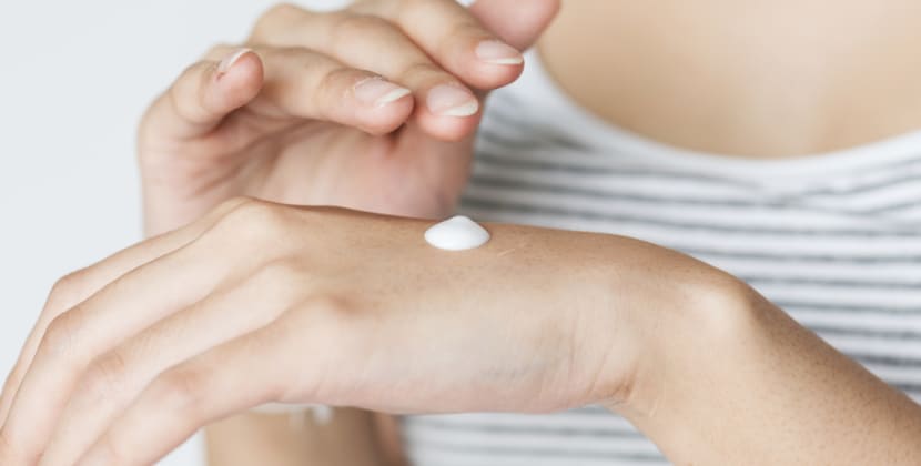 Banner Image of a woman putting cream on her hands