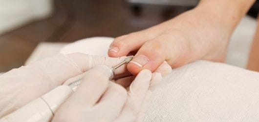 young-woman-doing-pedicure-salon Image of a woman having a pedicure