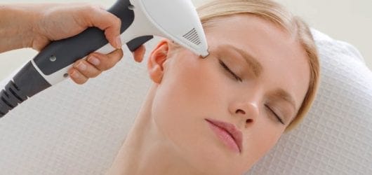 viora-ipl-face Image of a woman having a skin tightening treatment on her face