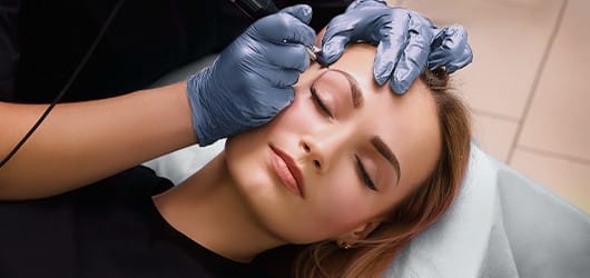 Eyebrow Microblading, permanent makeup Image of a beautician performing an eyebrow microblading