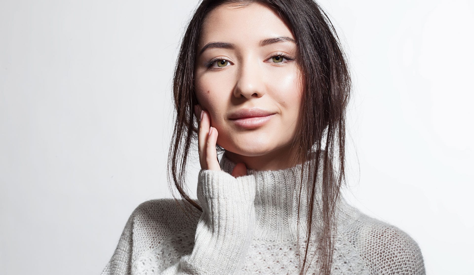 woman touching her face concerned with dry winter skin