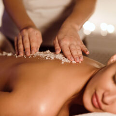 woman having a salt scrub spa treatment